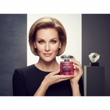 Sloane Sterling, a stylish woman, smiles confidently while holding the Jimmy Choo Blossom Eau de Parfum Spray 100ml bottle. T